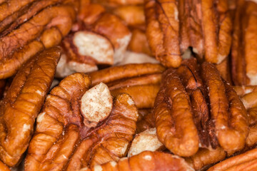 Heap of peeled pecan nuts close-up in selective focus