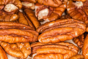 Heap of peeled pecan nuts close-up in selective focus