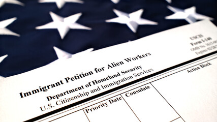 I-140 Immigrant petition for alien workers blank form lies on American Flag background