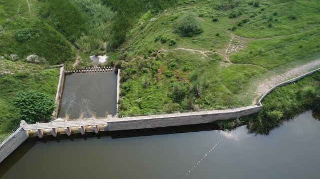 scenic view of small dam spillway in pakistan showing flowing water stream and rural engineering structure landscape dungi village gujjar khan rawalpindi