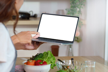 Couple Cooking Together with Digital Recipe on Tablet