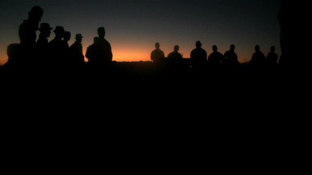 Marines Talking at Sunset Silhouette in Desert