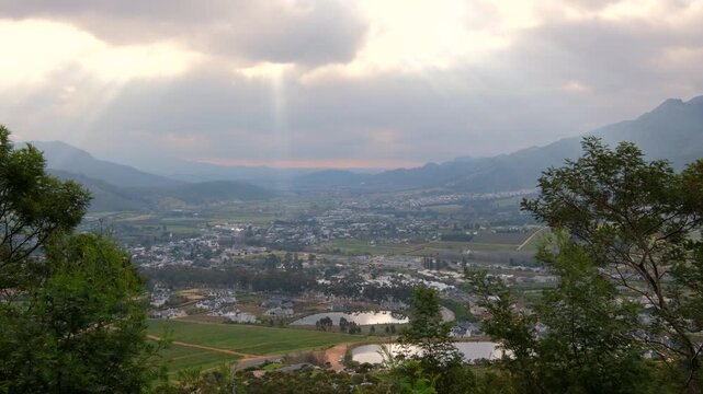 Crepuscular rays illuminate tourist destination of Franschhoek, lookout point