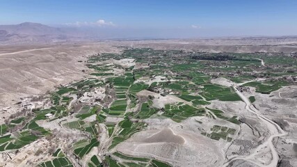 Aerial Drone View Of Nangarhar Landscape With Green farming Fields, Hills in desert land In Afghanistan, Nuristan.
