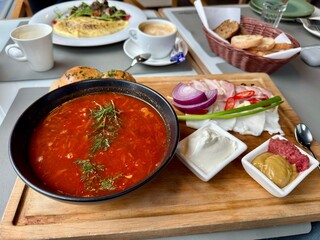 Traditional borscht soup with meat, sour cream, and bread