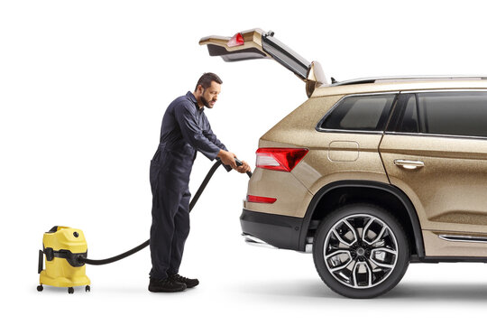 Man cleaning a SUV with a vacuum cleaner