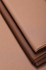 Luxurious cashmere suiting fabric in warm autumn shades, neatly folded. Perfect for fashion, tailoring, craftsmanship, and seasonal textile concepts.