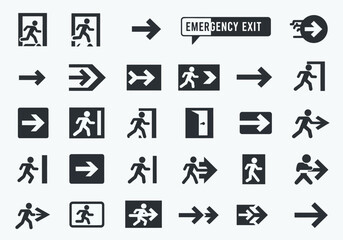 An array of emergency exit  directional signs shown in black on a light background