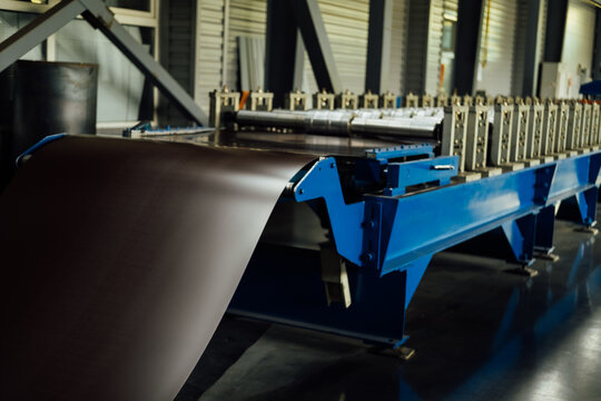 Industrial equipment for working with coil metal. Decoiler holds and unwinds metal coil. Slitting or cut-to-length line - cut coil metal into strips