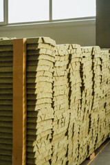 Basalt insulation, mineral wool for sandwich panels are stacked in a pack on top of each other, view from the side