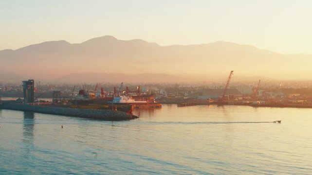 Ensenada, Mexico. August 27, 2025: Sunrise over Bah&iacute;a de Todos Santos in Ensenada, with the port and distant mountains providing a tranquil backdrop to the bustling harbor