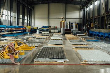 The production warehouse area of a factory for processing rolled metal into building materials, for example, corrugated board, metal tiles, siding