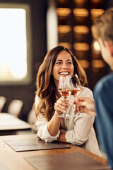 Smiling Woman Toasting With Man in Cozy Restaurant Ambience