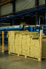 Basalt insulation, mineral wool for sandwich panels are stacked in a pack on top of each other, view from the side.