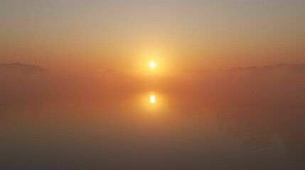 Fototapeta premium 3D render of sunrise above tranquil lake, reflective water mirroring warm golden light, mist drifting in volumetric layers, realistic shading combined with stylized atmosphere for