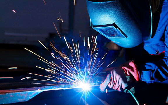 worker welding metal - Powered by Adobe