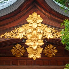 Ornate golden floral carvings on a wooden temple roof