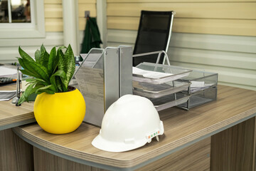 Civil construction engineer working at the desk office with white safety hard hat. Architecture project manager.