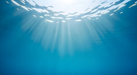 underwater sun rays through clear blue ocean water