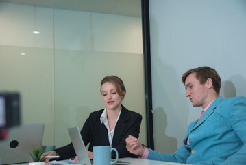 Professional individuals engage in business meeting, discussing ideas and strategies. atmosphere is focused and collaborative, showcasing teamwork in modern office setting