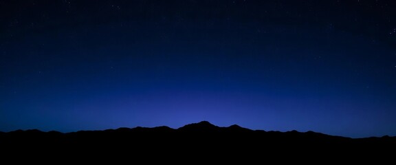 Dark blue, purple, and black washes create a moody, starry night sky over a silhouetted mountain range,  art,  vibrant