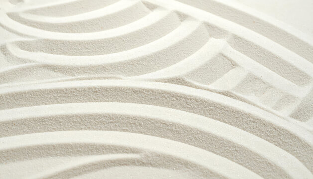 Abstract white sand patterns creating a calming and meditative zen garden texture, perfect for backgrounds