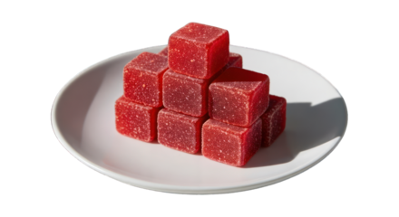 Stacked red cubes on a white plate, dark shadow behind