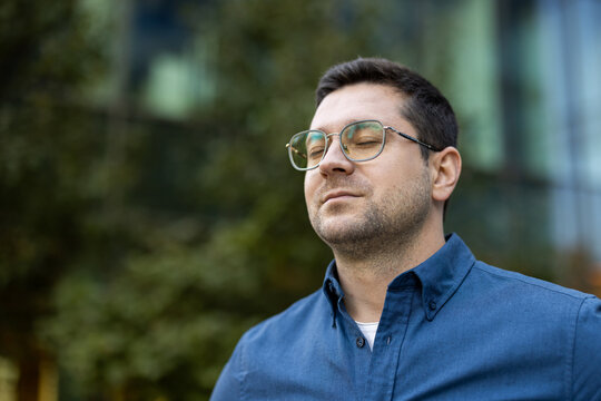 Man with closed eyes enjoying a moment of calm and peace outdoors, breathing deeply and practicing mindfulness for stress relief and mental well-being - Powered by Adobe