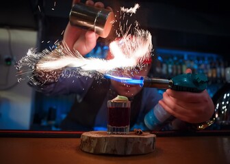 Bartender making flaming cocktail with fire show