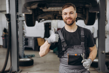 Auto mechanic giving thumbs up for quality service