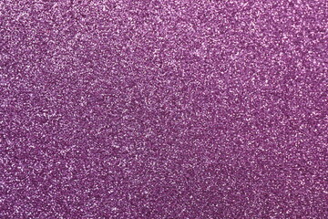 A textured background featuring a deep violet color with subtle glitter accents