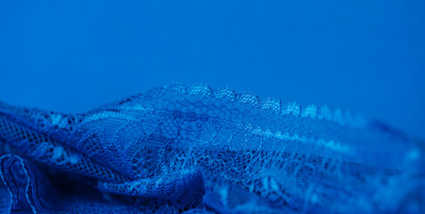 Blue lace edge on blue background, shallow focus