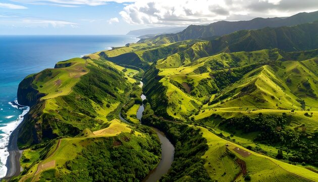 Lush green hills meet a winding river alongside a dramatic coastline