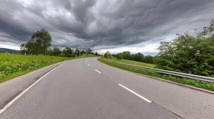 Fototapeta premium asphalt. Panoramic view of an empty road under cloudy skies, capturing a serene and open landscape. travel magazines, destination branding, designed for outdoor magazines and nature guides.