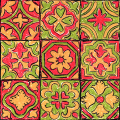 Seamless ornamental tile pattern. Vintage floral and geometric motifs hand drawn with pastel crayons in red, orange and green. Decorative retro design for fabric and wallpaper.