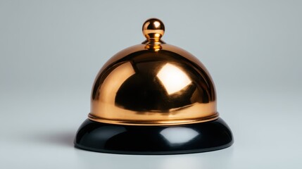 A polished reception bell sits elegantly against a smooth backdrop, representing hospitality and prompt service with a touch of sophistication.