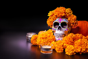 Painted skull with orange marigold flowers.  Dia De Los Muertos holiday.