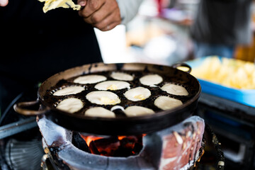 Khanom Khai in hot pan make by Thai trader, Khanom Khai is a Thai oval sweetmeat made with egg and sugar