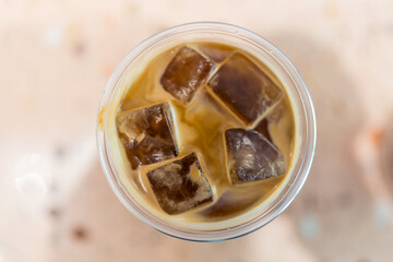 Top view of a cold coffee beverage featuring ice, perfect for summer refreshment