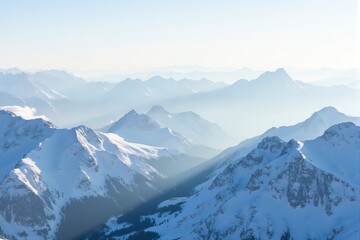 Obraz premium Snow-covered mountains under a clear blue sky.