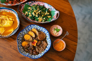Traditional Thai dishes with curry, braised pork and vegetables