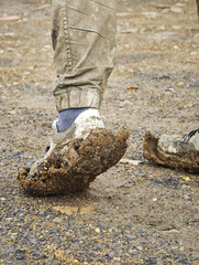Person's foot is covered in mud and dirt