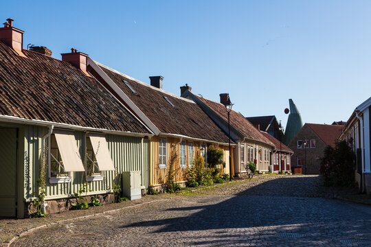 Idyllic cobblestone street with colorful wooden houses in the old town of Falkenberg in Sweden in autumn