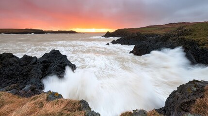 Dramatic Coastal Sunset with Waves Crashing on Rocks