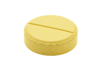 Isolated yellow tablet with score line ready for use in a medical or pharmaceutical design