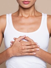 Close-Up of Woman With Hands Over Chest in Casual White Tank Top