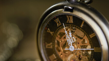 Fototapeta premium Gears, inner workings, and white hands of a golden vintage pocket watch, macro shot. Time, inspiration, and antique concepts.