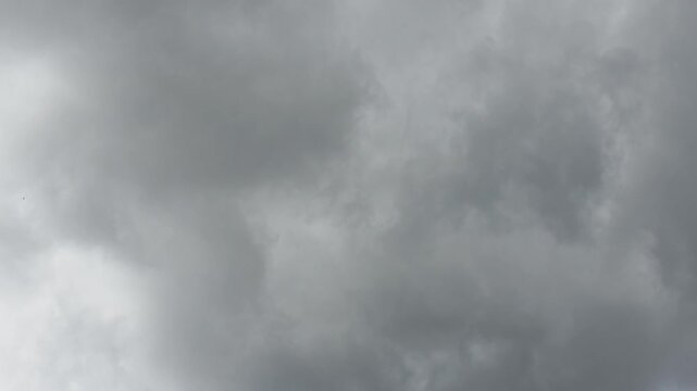 Dramatic sky with grey clouds and scattered rays of light, hyperlapse, cloudy sky in 27798 Hude, Germany