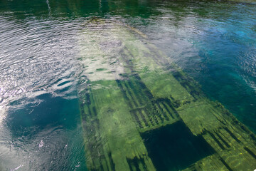 Old shipwreck in Big Tub Harbour, Tobermory, Ontario. A fascinating glimpse into maritime history beneath clear, tranquil waters.