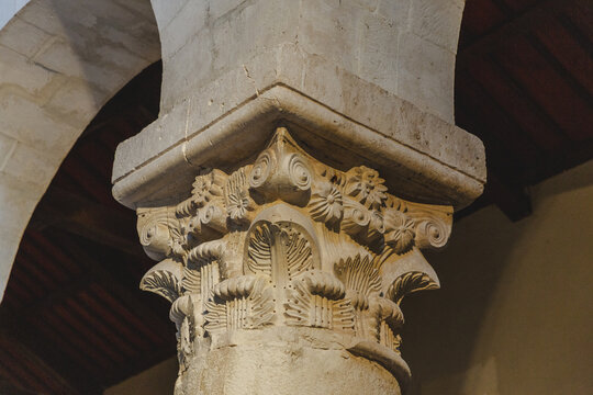 View of intricately carved stone capital, adorned with floral motifs, stands as a testament to ancient craftsmanship, Bominaco, Abruzzo, Italy.